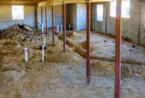 Concrete foundation with support piers and footings under a home in Charlotte, NC