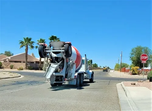 Concrete mixer truck delivering ready-mix concrete to a residential street