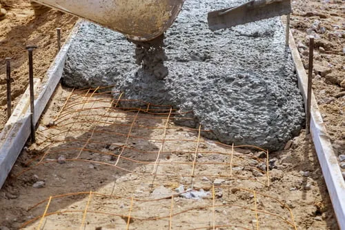 Concrete being poured over a rebar grid inside formwork on a Charlotte NC job site